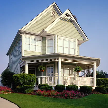 Victorian house with large front porch features Kelleher Advantage Plus exterior wood siding and wood trim
