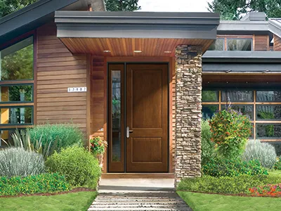 The over sized front entry of this home features a low-maintenance fiberglass front door from Therma-Tru