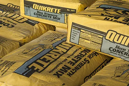 Stacked yellow bags of Quikrete High Strength Concrete Mix for general construction use