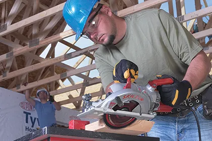 Contractor on job site uses a Skilsaw 15-amp 7-1/4 inch lightweight worm drive circular saw to cut a bevel
