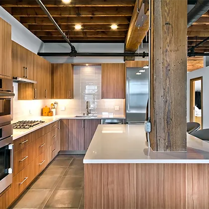 The vertical grain kitchen cabinets featured in this loft kitchen design include Spokane door styles for a modern, contemporary industrial look
