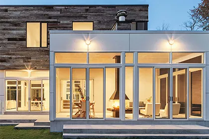 Very modern house design features lots of glass and two Marvin Signature Ultimate Sliding Patio Door for patio access