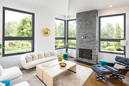 Modern living room featuring four Milgard C700 Fiberglass Series windows that maximize natural light and outdoor views