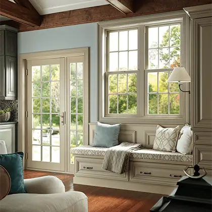 Simple elegance around the dinning room table featuring views of the garden through Milgard Tuscany vinyl window