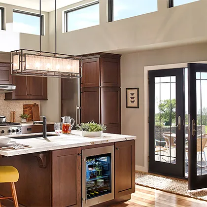 This amazing kitchen features plenty of light from upper story Ply Gem windows and the French doors that open to the patio area