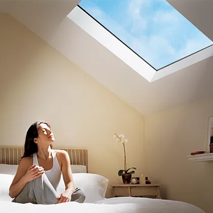 Upstairs bedroom takes advantage of the roof pitch to install a VELUX fixed skylight for natural daylighting
