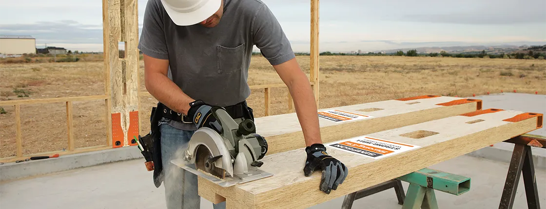 Contractor using a circular saw to field trim a Simpson Wood Strong-Wall shearwall at the job site